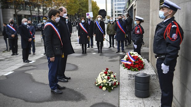 Saint-Denis Mayor Mathieu Hanotin, left, and French Prime Minister Jean Castex participate in a wreath laying ceremony, marking the 5th anniversary of the Nov. 13, 2015 attacks outside the stadium Stade de France in Saint Denis, near Paris, Friday, Nov. 13, 2020