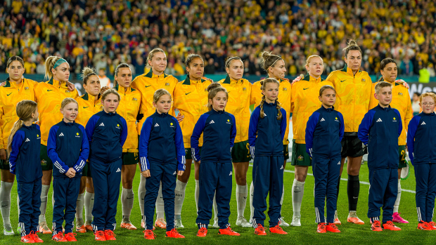 Australia players line up for the national anthems.