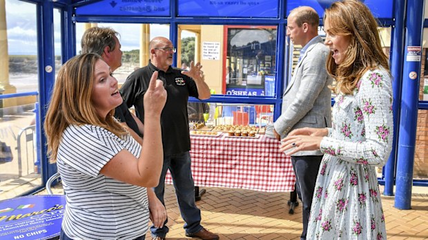 Britain's Prince William and Kate, the Duchess of Cambridge meet with business owners in Barry Island, Wales, Wednesday Aug. 5, 2020, during their visit to speak to local business owners about the impact of COVID-19