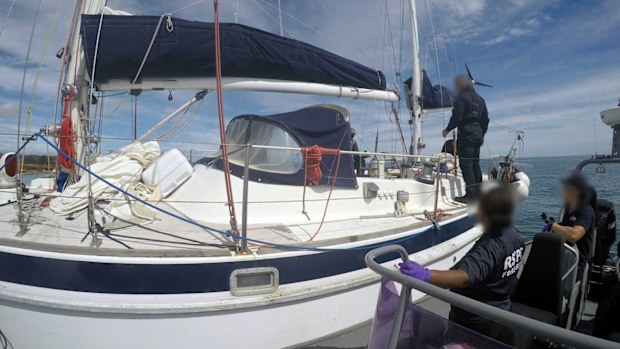 Police officers board a boat in the Solomon Islands.