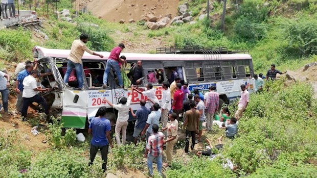 Rescuers pull out passengers from a bus that fell into a gorge in Jagtiyal district of Telangana, India.