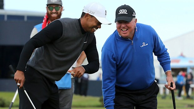 Tiger Woods and Mark O'Meara share a joke in 2015