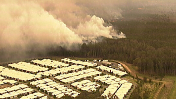 9News was told the fire has burnt right up to gardens in some homes at Lakes Innes and Lake Cathie.