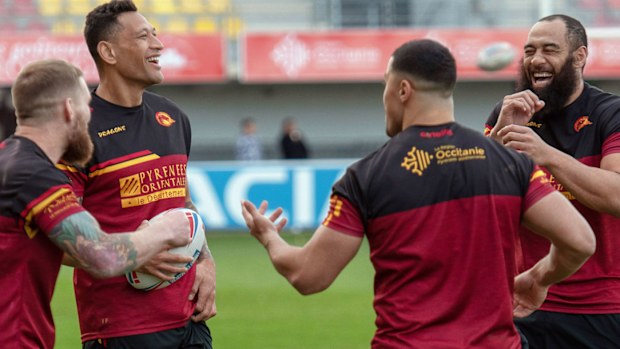 Australia's Israel Folau, second from left, smiles with teammates during a training session with his new club Catalan Dragon