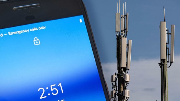 A phone with no reception and two mobile towers