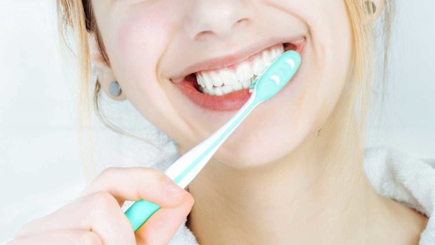 Close up of woman brushing teeth