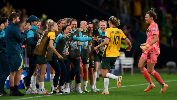 Emily van Egmond celebrates with substitute Sam Kerr and the rest if the Matildas' squad after scoring the opening goal of Australia's match against Nigeria.