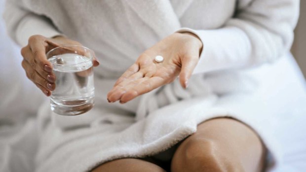 Generic image of woman taking tablet / paracetemol / panadol