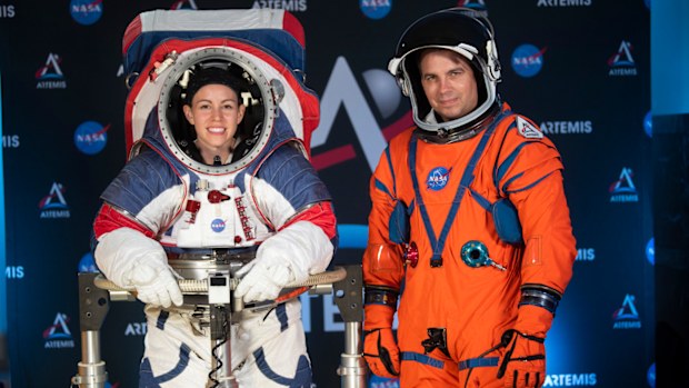 The two NASA spacesuit prototypes for lunar exploration, one for launch and re-entry aboard the agency's Orion spacecraft, known as the Orion Crew Survival Suit, is worn by Dustin Gohmert, right, and one for exploring the surface of the Moon's South Pole, known as the Exploration Extravehicular Mobility Unit (xEMU) is worn by Kristine Dans.
