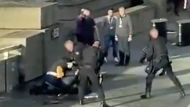 The terror suspect is grappled to the ground.