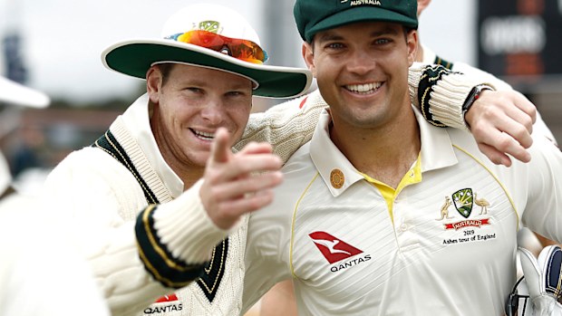 Smith shares a joke with Carey