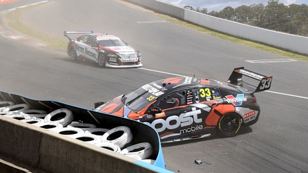 Richie Stananway in the Boost Mobile Racing Holden inspects damage after crashing during practice 