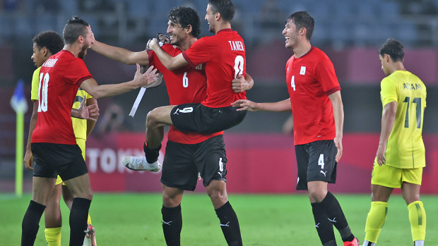 Ahmed Hegazy #6 of Team Egypt celebrates with Ramadan Sobhi #10 and Taher Mohamed #9 after victory 
