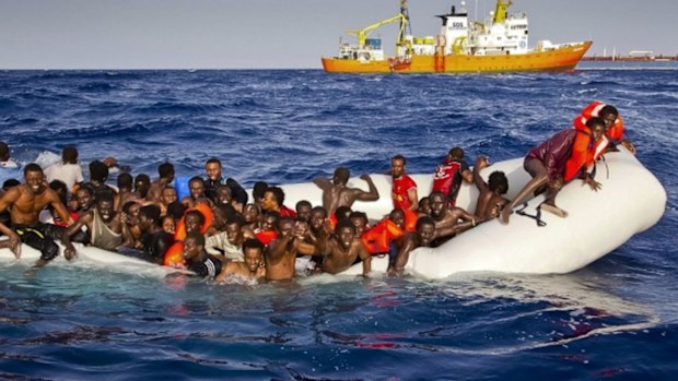 Migrants ask for help from a dinghy in the Mediterranean on Sunday.