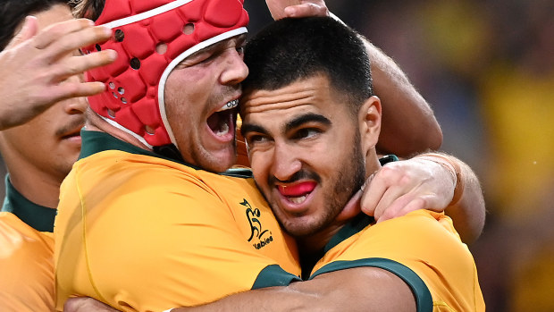Tom Wright of the Wallabies is congratulated by team mates after scoring a try