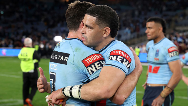 Cody Walker embraces Mitchell Moses after inspiring NSW to victory in Origin III, 2023.