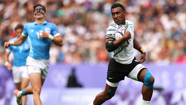 Fiji's Joji Nasova streaking away to score in Paris.