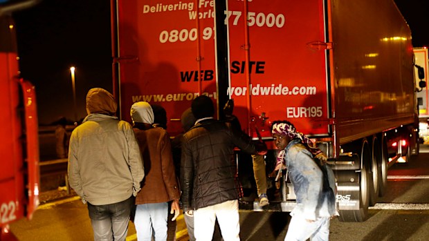 Migrants open a lorry in a failed attempt to cross the English Channel, in Calais. file photo (AAP)