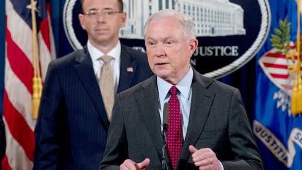 Attorney General Jeff Sessions accompanied by Deputy Attorney General Rod Rosenstein, left, speaks at a news conference to announce an international cybercrime enforcement action at the Department of Justice. (AAP)