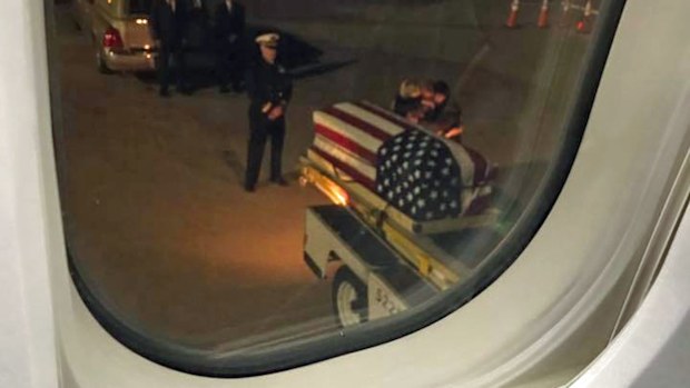 The photo taken by Mike Helms of Brooke Newton's family greeting her casket.