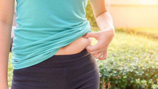 Woman holding belly fat