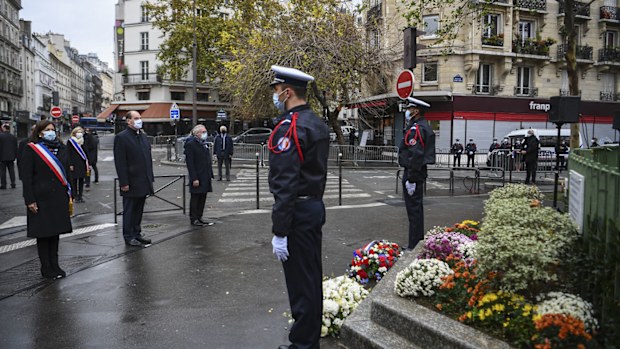 Paris Mayor Anne Hidalgo, left, and French Prime Minister Jean Castex, 2nd left, participate in a wreath laying ceremony, marking the 5th anniversary of the Nov. 13, 2015 attacks outside the Bonne Biere cafe bar in Paris, Friday, Nov. 13, 2020