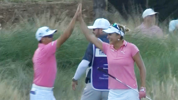 Lexi Thompson high fives playing partner Rickie Fowler after she hit a hole in one at the par-3 16th at the Grant Thornton Invitational.