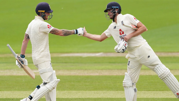 Ben Stokes and Dom Sibley of England punch gloves 