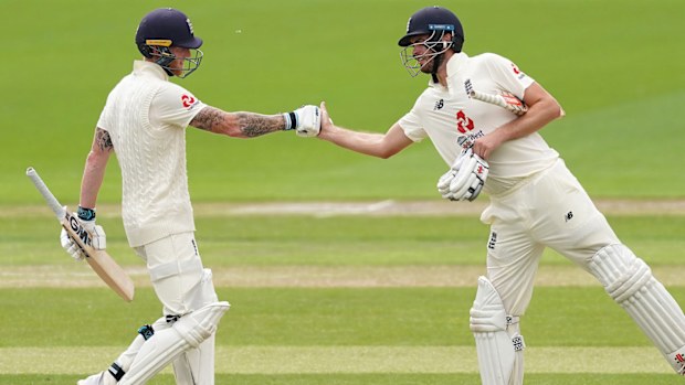 Ben Stokes and Dom Sibley of England punch gloves 