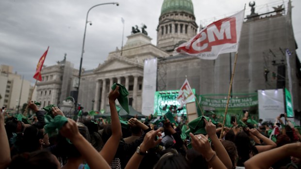 Abortion-rights activists celebrate as Argentine lower house approves a bill that would legalise abortion outside Congress in Buenos Aires, Argentina, Friday, Dec. 11, 2020