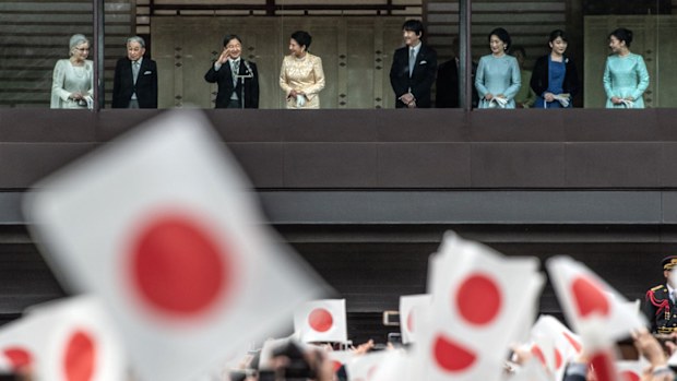 Well-wishers wave flags as Emperor Naruhito of Japan waves after delivering a traditional New Year's greeting at the Imperial Palace on January 2, 2020 in Tokyo, Japan. 