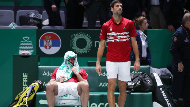 Novak Djokovic of Serbia and team mate Viktor Troicki react to the loss