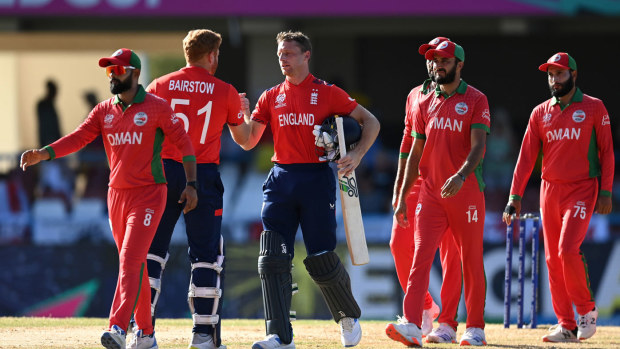 Jos Buttler and Jonny Bairstow come together to shake hands after batting England to victory against Oman.