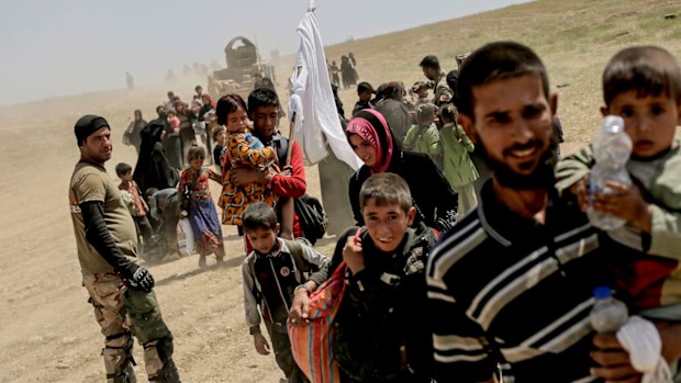 Residents flee the western part of the city as fighting between Iraqi forces and the Islamic State group continues, in Mosul, Iraq. (AAP)