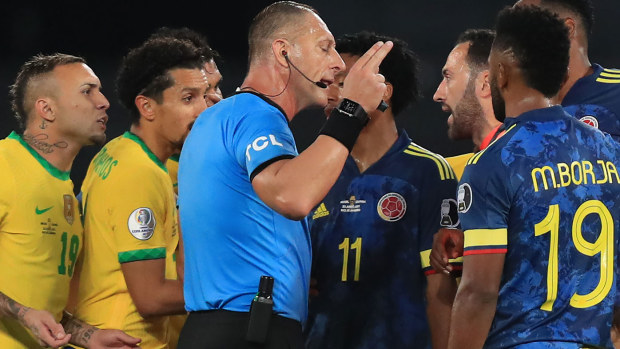 Colombia protest with referee Pitana after his interference led to a goal for Brazil.
