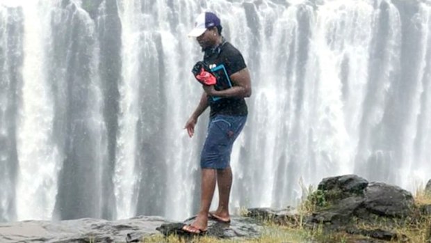 Roy George Tinashe Dikinya fell from the cliff moments after this photo was taken.