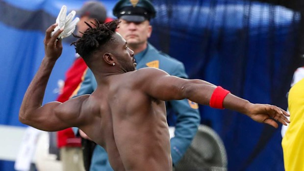 Tampa Bay Buccaneers wide receiver Antonio Brown throws his gloves into the stands.