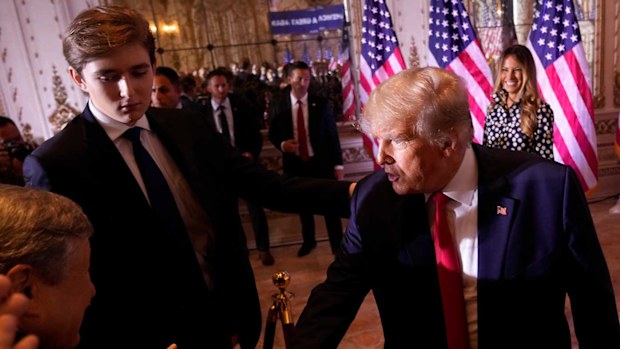 Donald Trump standing next to his son Barron after his election announcement speech.