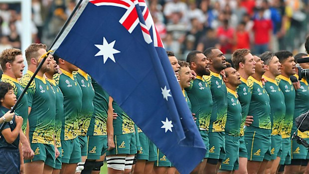 Australian players line up for the national anthem