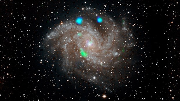 Scientists at NASA are perplexed by what made this distant galaxy glow blue and green.