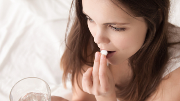 Woman taking a pill