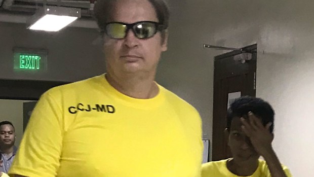 In this photo provided by the International Justice Mission, a global organization that partners with local authorities to fight human trafficking and child sexual abuse, Australian Drew Frederick Shobbrook, arrives at a regional trial court for sentencing Wednesday, Feb. 21, 2018, in Cebu city, central Philippines. Philippine court has sentenced Shobbrook to life imprisonment after finding him guilty on human trafficking and child pornography charges. (International Justice Mission via AP)