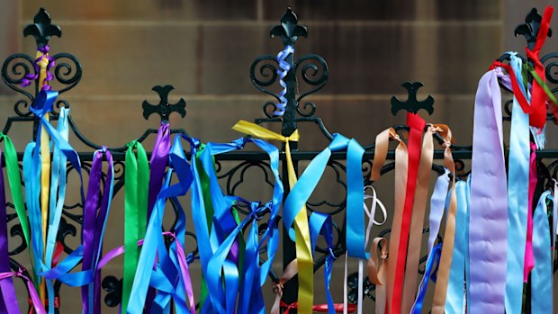 Rainbow ribbons attached to the gates outside the church.