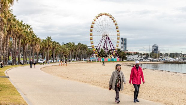 People are seen walking wearing face-masks along the Geelong Waterfront.