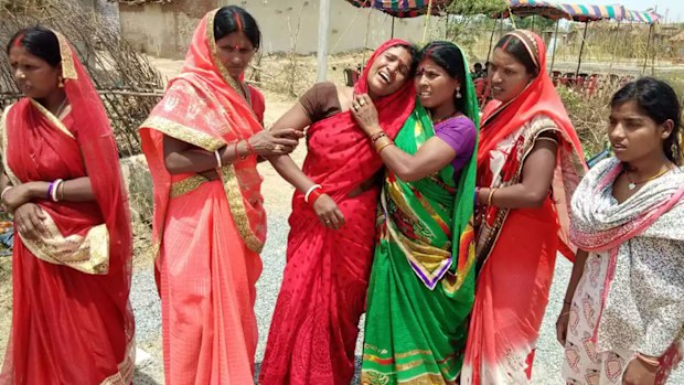 Relatives of the 16-year-old rape victim sob after she was burned alive. 