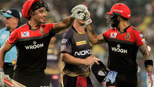 Royal Challengers Bangalore's Virat Kohli, right, and Marcus Stoinis encourage each other