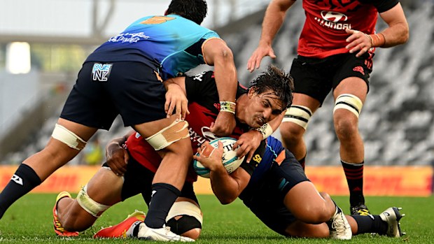 Pablo Matera of the Crusaders is tackled by the defence