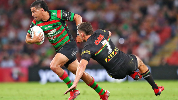 Cody Walker of the Rabbitohs beats the tackle of Nathan Cleary of the Panthers on his way to score a try 