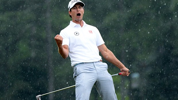 Adam Scott celebrates as the winning putt drops at the 2013 Masters Tournament.