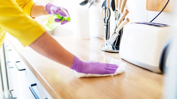 Cleaning the kitchen, wiping the bench